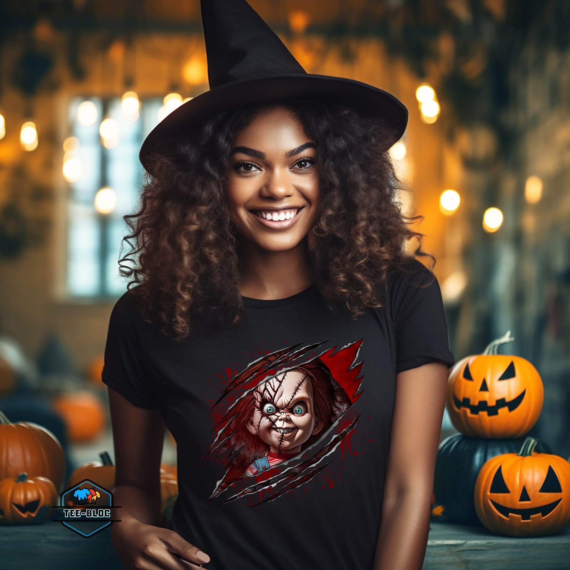 Woman wearing a black t-shirt with a Chucky graphic design, surrounded by Halloween pumpkins and decorations.