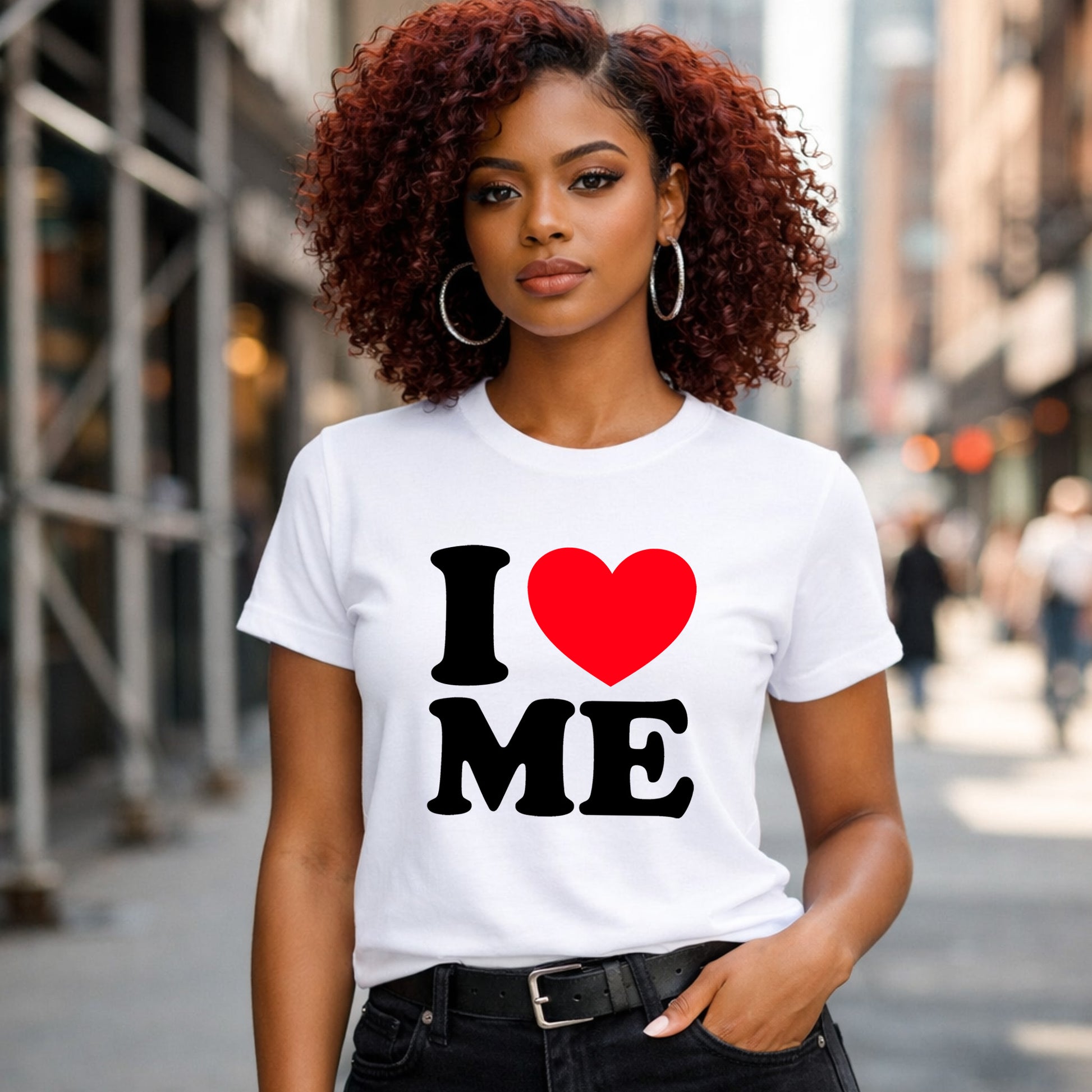 Woman wearing a white t-shirt with 'I ❤️ ME' on a city street.
