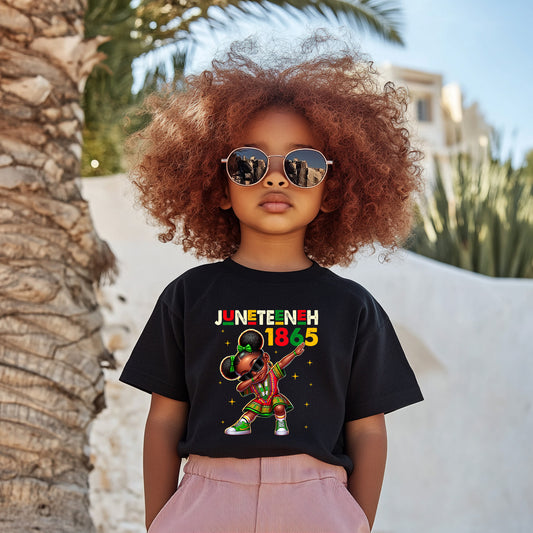 Child wearing a black t-shirt with Juneteenth 1865 design, standing outdoors.